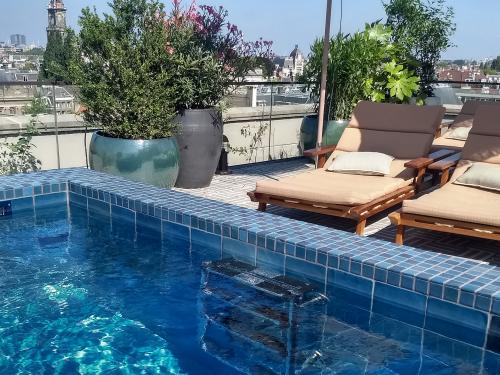 Swimming pool and deck chairs on a roof terrace